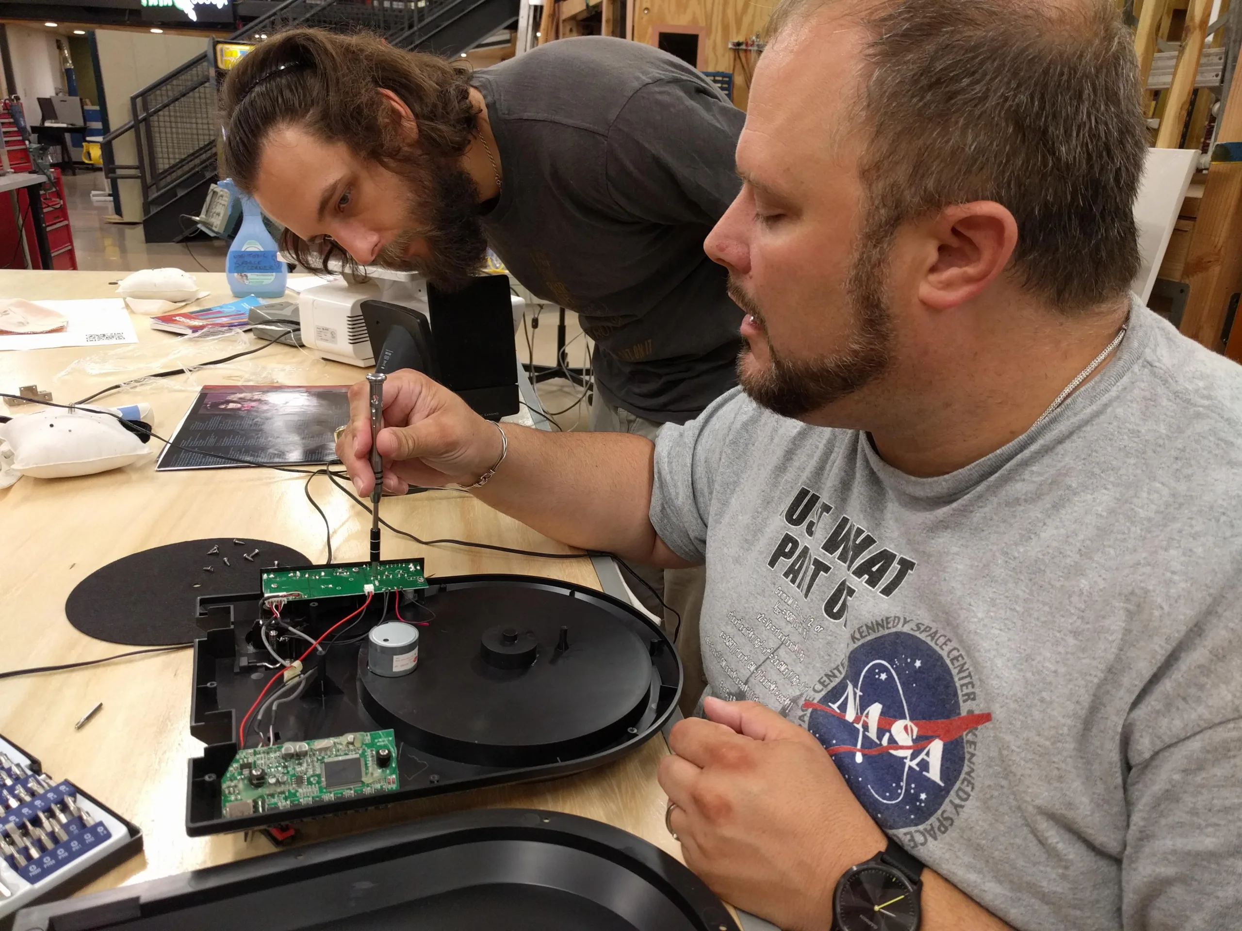 Two makerspace members work on an electronics project